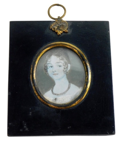 An early 19thC portrait miniature of a lady on ivory, in a black frame with gilt highlights, 7cm x 5½cm.