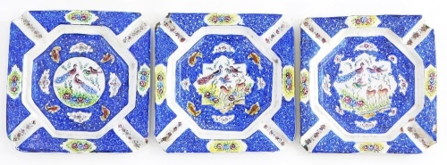 A set of three enamel hand painted ash trays, decorated with bird's, deer, flowers, etc., 10cm wide.