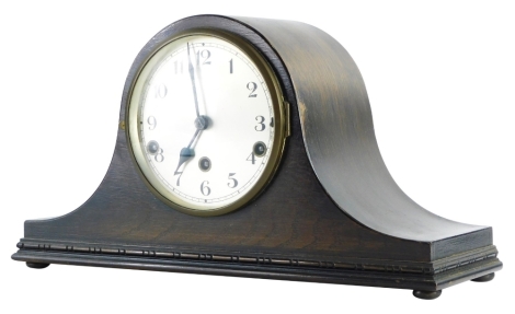 A 20thC oak cased Napoleon hat mantel clock, with Arabic numeral dial, chiming eight day movement.