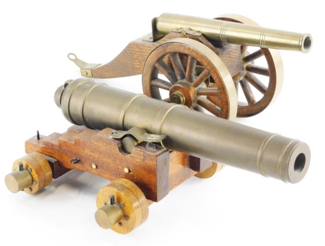 Two brass and treen framed table cannons, one based on a World War One British canon, 33cm long.