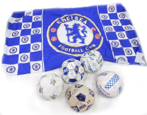 Five Chelsea football club signed footballs, and a flag.