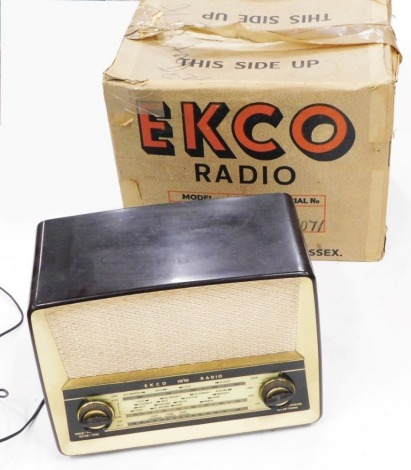 An Ekco brown and cream Bakelite radio, with original box, serial number 77071.