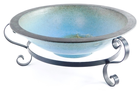 A studio pottery shallow bowl, with indistinct mark, initials LU, retailed by Lady Gate Galleries of Beverly East Yorkshire, on a metal wrought iron stand, 51cm diameter.