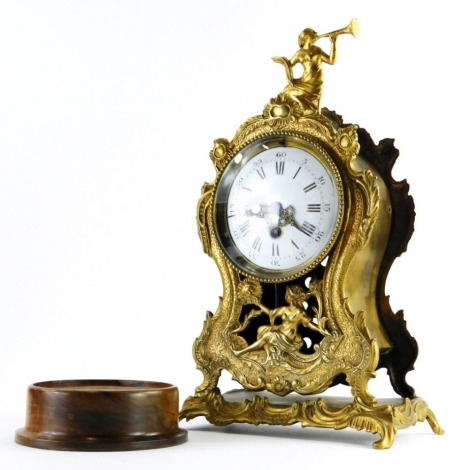 A 19thC French mantel timepiece, in brass case, decorated with Neoclassical figures, etc., the white enamel dial with Roman numerals, on a rectangular stand, 39cm high.