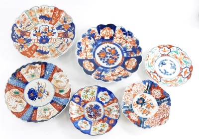 Three Japanese Imari plates or small chargers, each decorated with flowers within a lobed border, 30cm diameter, etc.