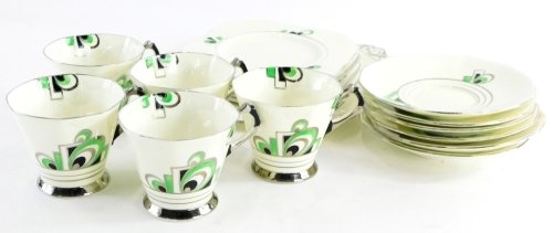 A Tuscan Plant Art Deco part tea service, decorated in green and black, within silver borders. (AF)