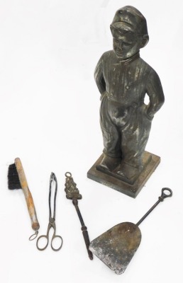 A bronzed metal fireside companion, modelled in the form of Dutch child, 51cm high.