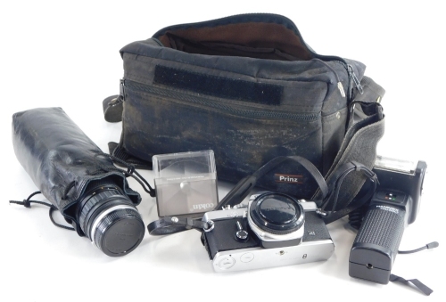 An Olympus OM1 camera, various lenses, and tri pod.