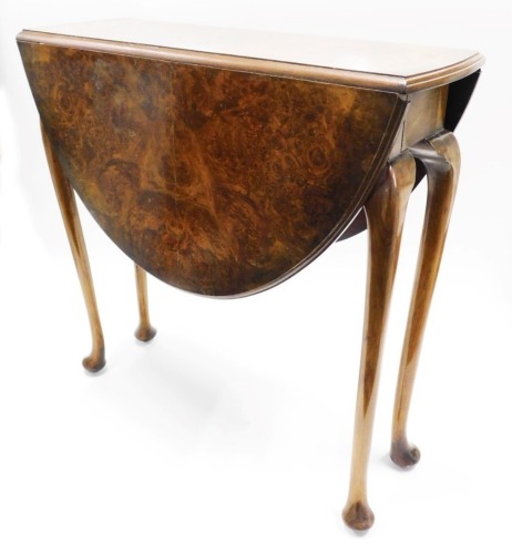 A burr walnut drop leaf table, the oval court and reared top on cabriole legs with pad feet, 69cm high, 90cm wide.