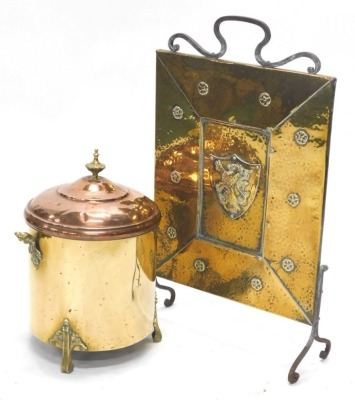 A hammered brass Arts and Crafts style fireguard, decorated centrally with a heraldic beast within a cartouche, and a copper and brass coal bucket, (2).