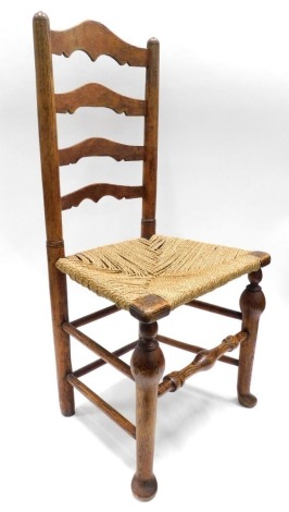 A Lincolnshire type ash ladder back chair, with a rush seat on cabriole legs.