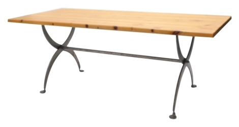 A pine rectangular kitchen or dining table, with a planked top on wrought iron X shaped supports, with circular feet, the top 196cm x 89cm.