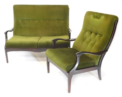 A mid 20thC Parker Knoll ebonised two seat sofa, upholstered in green fabric and a matching armchair. The upholstery in this lot does not comply with the 1988 (Fire & Fire Furnishing) Regulations, unless sold to a known exporter or upholsterer it will be 