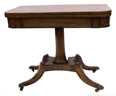 A George IV rosewood card table, the rectangular top with rounded top enclosing a baize lined interior, on a chamfered tapering column with concave platform and splayed legs with brass castors, 92cm wide.