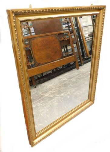 A late 19th/ early 20th gilt gesso wall mirror, 113cm x 92cm.