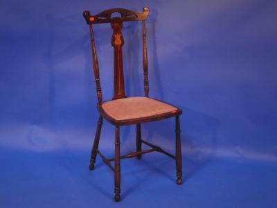 An Arts and Crafts single chair with a pierced top rail