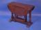 A small oak oval gate leg table with turned supports and flat stretchers