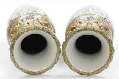 A pair of 19thC Chinese Canton porcelain baluster vases, with gilt kylin handles and applied chilin to the shoulders, decorated with panels of figures at court, birds, flora, and insects, in a famille rose palette, 46cm high. - 12