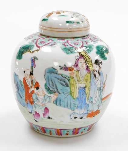 A Qing dynasty late 19thC famille rose porcelain ginger jar and cover, decorated with figures in a garden setting, the lid with children playing, four character Qianlong mark in red to the base, 20cm high.