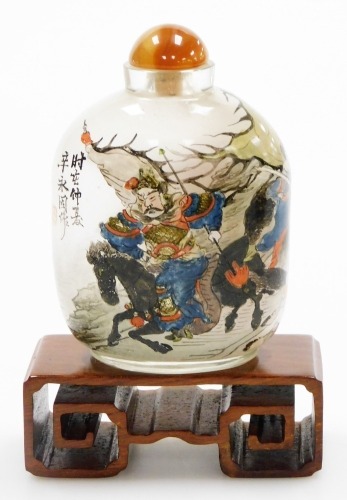 A Chinese inside painted glass snuff bottle, with stopper, painted with warriors, signed, 10cm high.