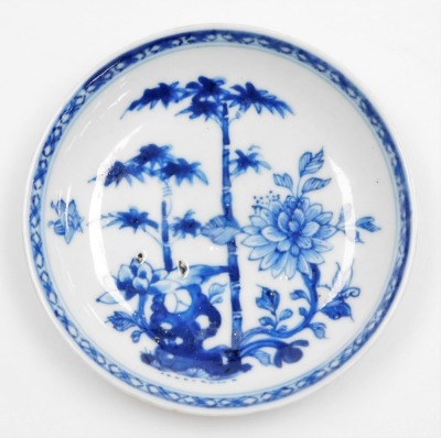 A Chinese blue and white porcelain saucer, painted with 'The Three Friends' within diaper border, probably 18thC, 11.5cm wide.