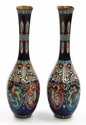 A pair of Japanese Meiji period cloisonné vases, each with six sided elongated neck above bulbous bodies decorated with multicoloured dragon phoenix lappets above floral and geometric bands, 30cm high. (AF) - 3