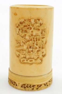 A 19thC Chinese Canton carved ivory spill vase, of cylindrical form, having two opposing cartouches, carved with pagodas, figures and foliage, on an attached pierced circular base, 10cm high.