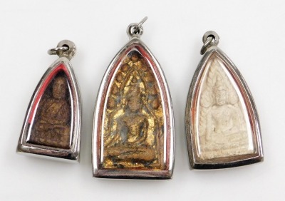 A group of Eastern pendants, each with stone carving of seated Gods, in domed and glazed stainless steel frames. (a quantity) - 8