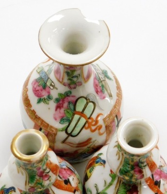 A group of Qing dynasty Canton famille rose porcelain pieces, decorated with reserves of figures birds, butterflies and flowers, against a floral ground, comprising teapot and cover, jar and cover, pair of gourd vases 9cm high, and a further vase. (5) - 6