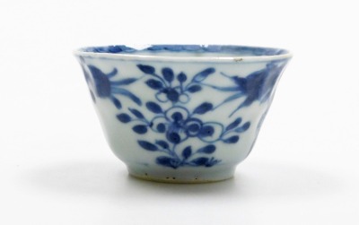 A Japanese early 20thC transfer printed blue and white fluted dish, decorated with birds, flowers and blossom, 31cm diameter, together with a Chinese blue and white tea bowl and saucer decorated with vases of flowers, probably 18thC. (3) - 8