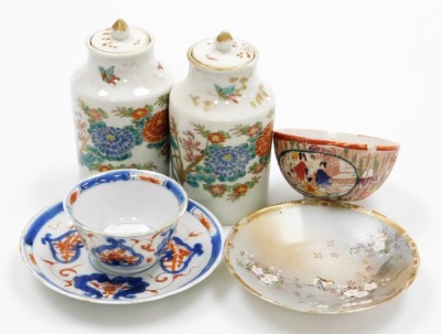 A pair of Meiji period Arita porcelain jars and covers, decorated with chrysanthemums, 12cm high, together with an 18thC Chinese Imari teabowl and saucer, a Kutani bowl, and Kutani saucer. (6)