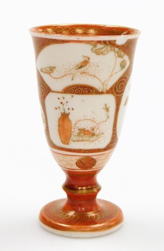 A Japanese Meiji period miniature Kutani goblet, with overlapping shaped panels on an orange and gilt ground, marked Kutani to the base, 8cm high.