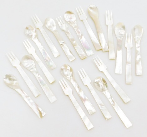 A small group of mother of pearl cutlery, comprising ten forks and ten spoons.