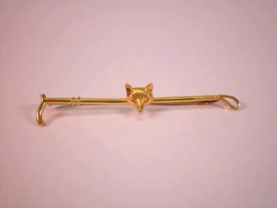 A 9ct gold stock pin of crop & foxes mask