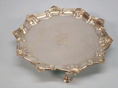 A George III silver waiter with a pie crust border cast with acanthus with