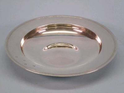 A silver armada dish with a double reeded border and concave base