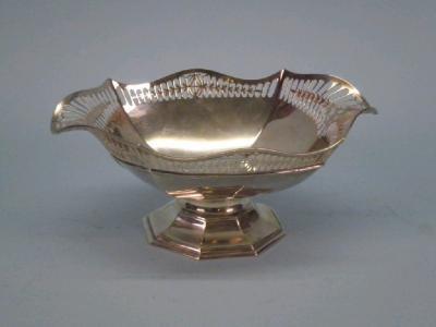 A silver rectangular fruit bowl with shaped pierced sides decorated with