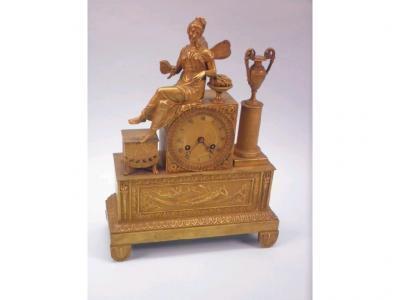 A mid 19thC French gilt metal mantel clock in the form of a fairy seated