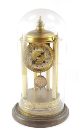 A continental brass mantel clock, the circular dial with silvered Arabic numerals, eight day movement striking on a bell, the case of temple form with six fluted columns, under a glass dome, with key, 38cm high.