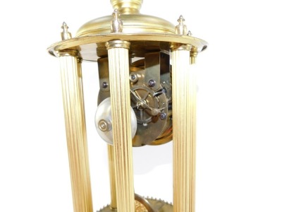 A continental brass mantel clock, the circular dial with silvered Arabic numerals, eight day movement striking on a bell, the case of temple form with six fluted columns, under a glass dome, with key, 38cm high. - 7