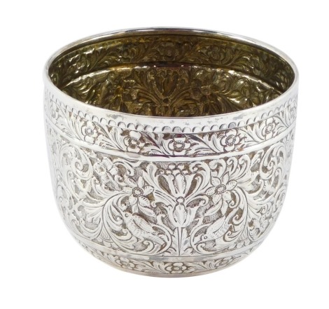 A Victorian silver drinking cup, with hammered floral detailing and central circular crest bearing the initials BMV, with front inscription From Her Uncle and Aunt J & CB, October 1885, Charles Stuart Harris, London 1884, 8cm high, 6¾oz.