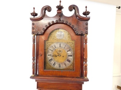 An early 19thC flame mahogany cased long case clock, the brass break arch dial with silver chapter ring bearing Roman numerals, subsidiary seconds dial, eight day two train movement with bell strike, the case hood with broken arch pediment for floral fini - 2