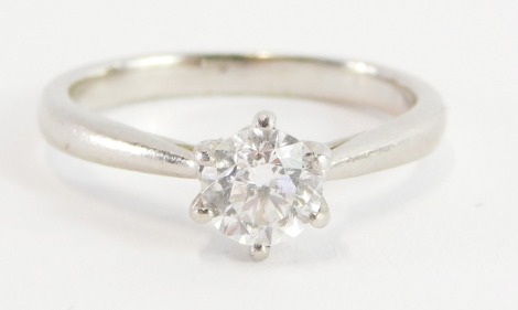 A platinum and diamond solitaire ring, with old cut diamond, approx 0.76cts, in a four claw setting with V splayed shoulders, size L, misshapen, 4.3g all in., in a Lustro box.