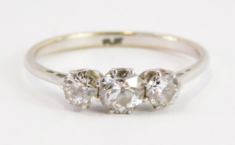 A three stone diamond ring, with three old brilliant cut diamonds, each in claw setting, central stone 0.34cts, flanked by two smaller stones each approx 0.19cts, ring size U½, 4g all in.