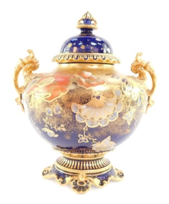 A Royal Crown Derby porcelain vase and cover, circa 1913, of twin handled baluster form, painted with flowers against a gilt and cobalt blue ground, printed and painted marks, 22cm high.