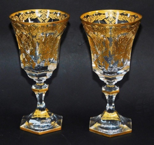 A pair of Cristal Sevres cut glass wine glasses, of hexagonal form, gilt decorated, marked De Lamerie, London, etched mark, 19cm high. (2)