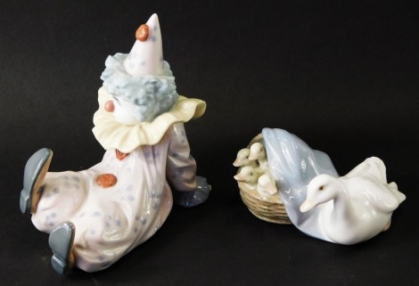 Two Lladro figure groups, comprising a group of geese, 10cm wide, and a figure of a seated clown, 12cm high. (2)