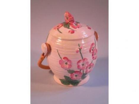 A Maling lustre biscuit barrel and cover decorated overall with pink flowers