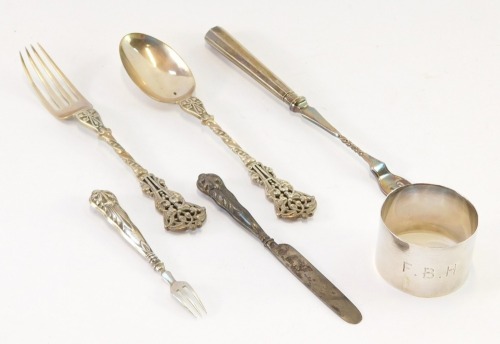 A group of silver, comprising a George VI silver napkin ring initialled FB, Birmingham 1942, Victorian silver scroll design fork and spoon set, Goldsmiths & Silversmith Company, London 1894, silver handled pickle fork and a Victorian silver butter knife,