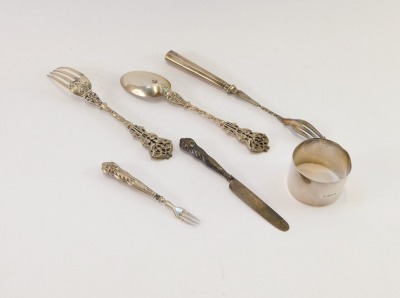 A group of silver, comprising a George VI silver napkin ring initialled FB, Birmingham 1942, Victorian silver scroll design fork and spoon set, Goldsmiths & Silversmith Company, London 1894, silver handled pickle fork and a Victorian silver butter knife, - 2